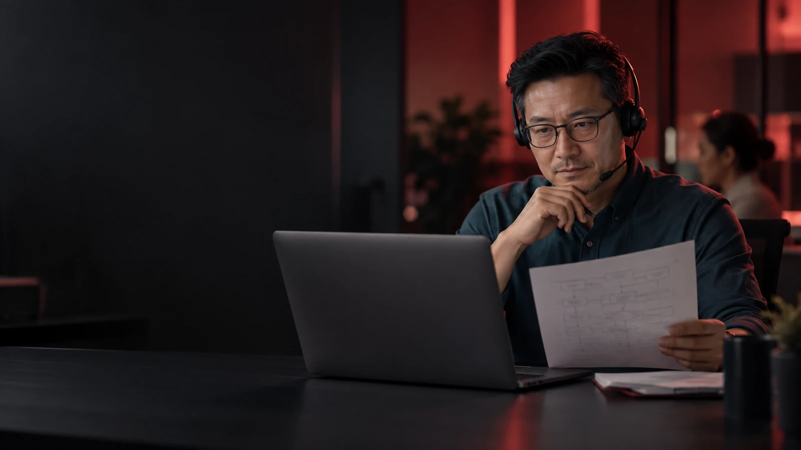 Customer-service professional reviewing a workflow at a laptop