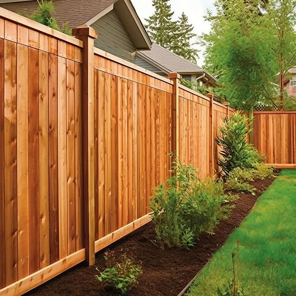 Cedar wood privacy fence installed along a landscaped backyard with shrubs and lawn