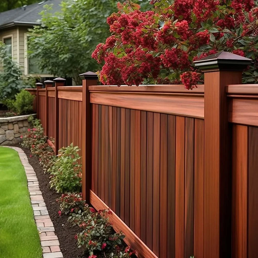 Mahogany wood privacy fence with flowering shrubs in a landscaped garden