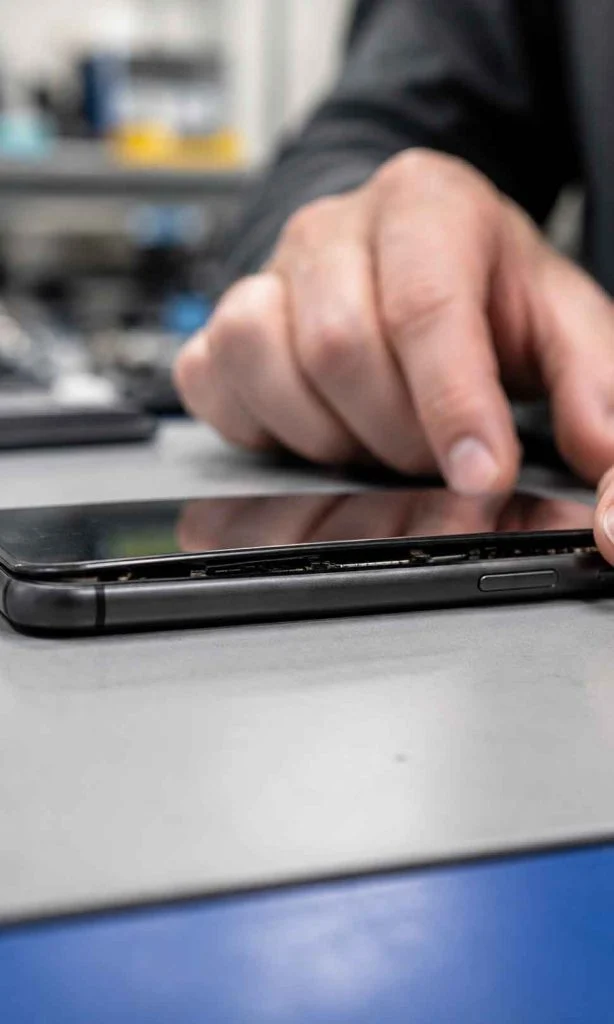 Close-up of a smartphone screen beginning to lift because of possible battery swelling