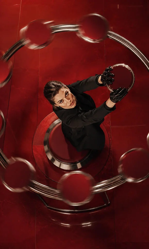 Woman resisting circular red objects orbiting around her head as a metaphor for repetitive thoughts