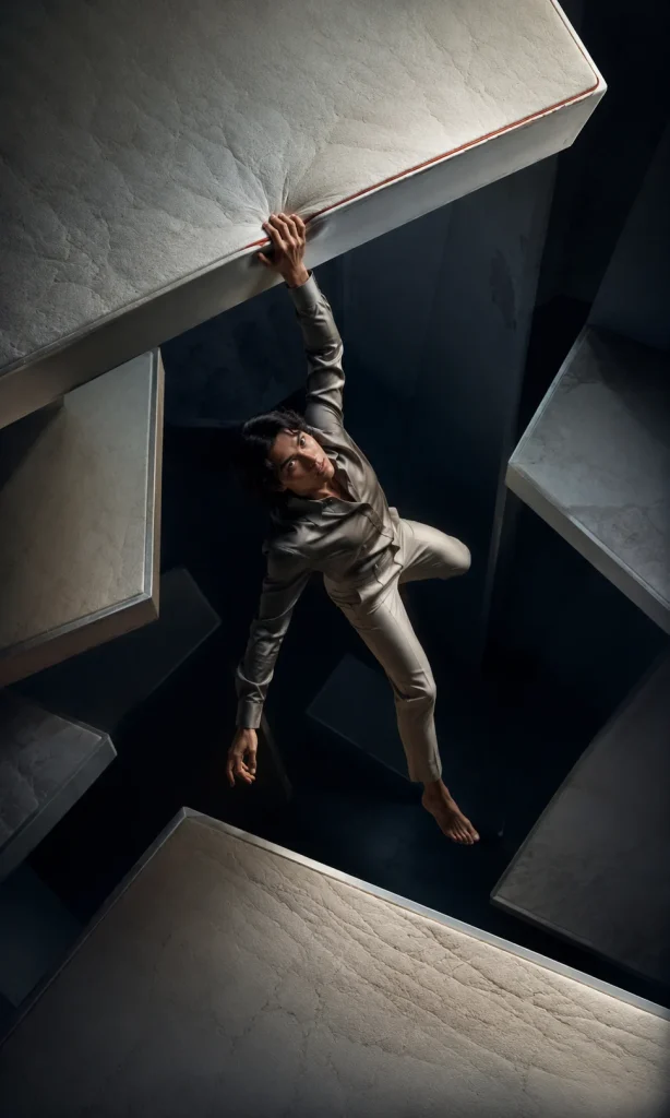 Person falling between suspended mattress layers representing disrupted sleep in depression