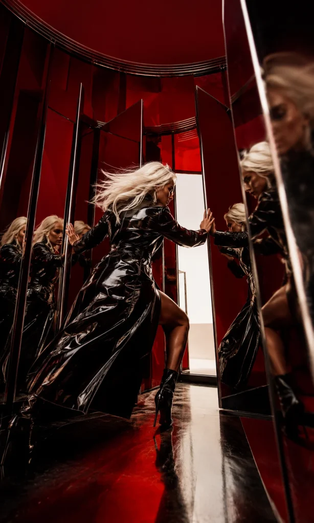 Woman pushing through rotating red mirrors representing rumination versus productive reflection