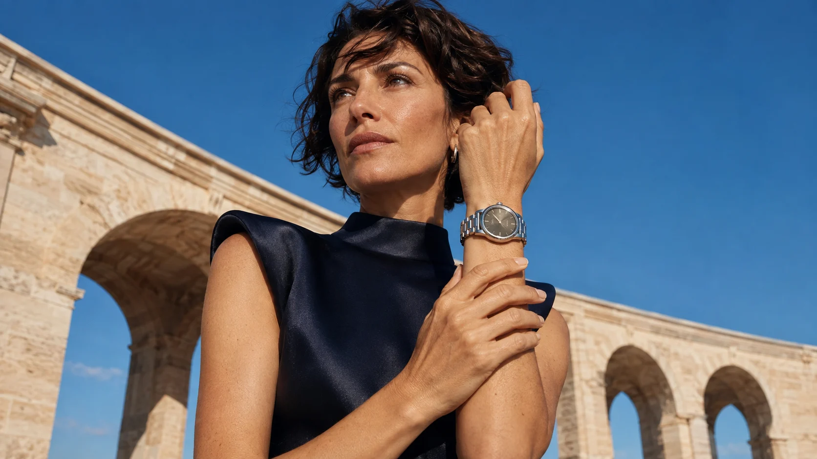 Woman checking the fit of a wristwatch against her wrist in a luxury editorial setting