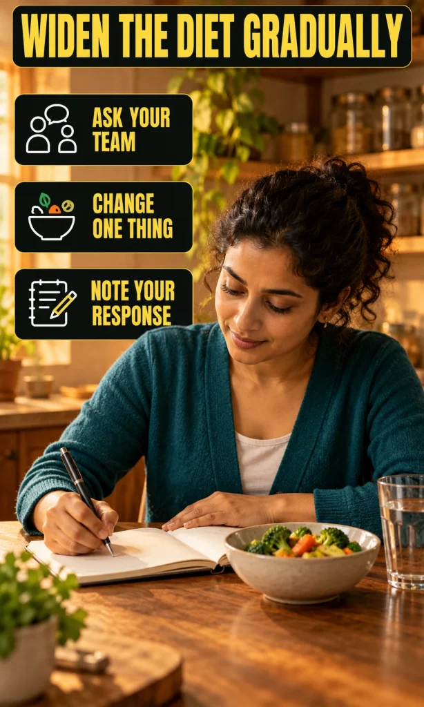 Woman recording one food change in a notebook beside a small portion of cooked vegetables.